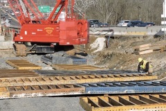 February 2022 - A worker assembles a concrete form for construction of a bridge abutment.