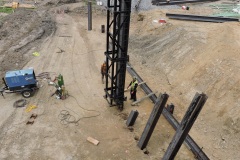 August 2021 - A pile driver is set up to drive another I-beam pile to support the embankment for construction of the northern abutment of the new bridge over Neshaminy Creek.